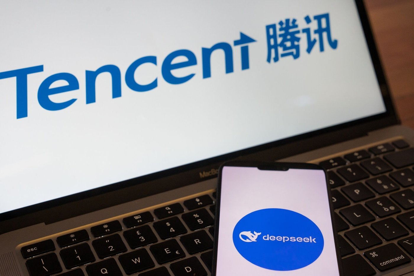 the logos for the deepseek ai service bottom and tencent holdings ltd arranged in beijing china 1